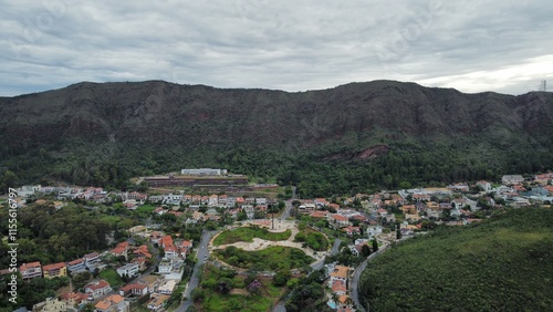 Aerial drone view of Praça do Papa and Serra do Curral in Belo Horizonte, Brazil. The photo shows the square, nearby houses, and the natural park area of Serra do Rola-Moça and Mangabeiras.