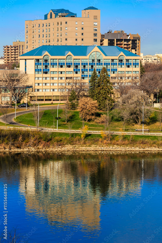 Fototapeta premium A large building with a blue roof is reflected in the water
