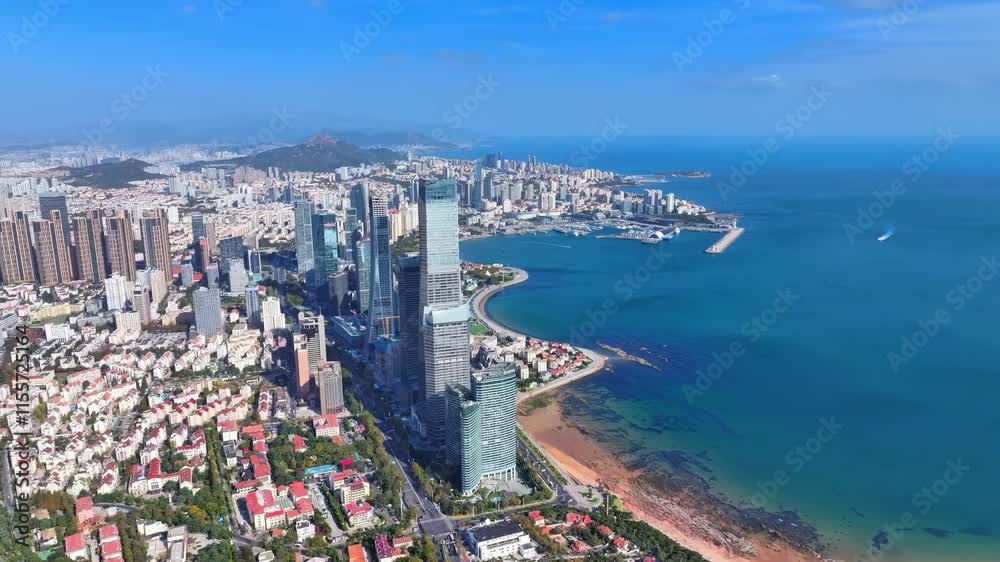 Stunning aerial view of coastal city with skyscrapers and blue sea under clear sky Stunning aerial view of coastal city with skyscrapers and blue sea under clear sky