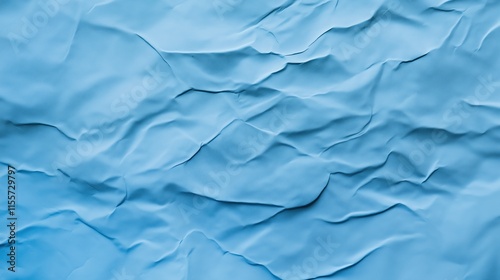 top view on light blue color crumpled paper, texture background  