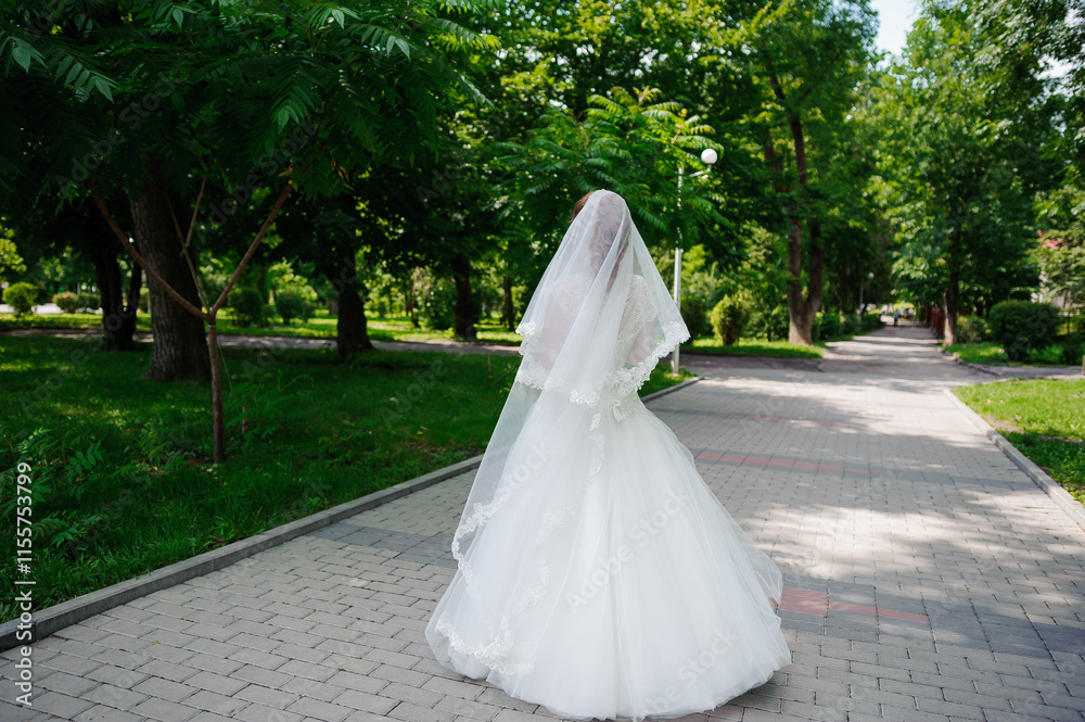 Elegant Bride Walking in a Lush Green Park