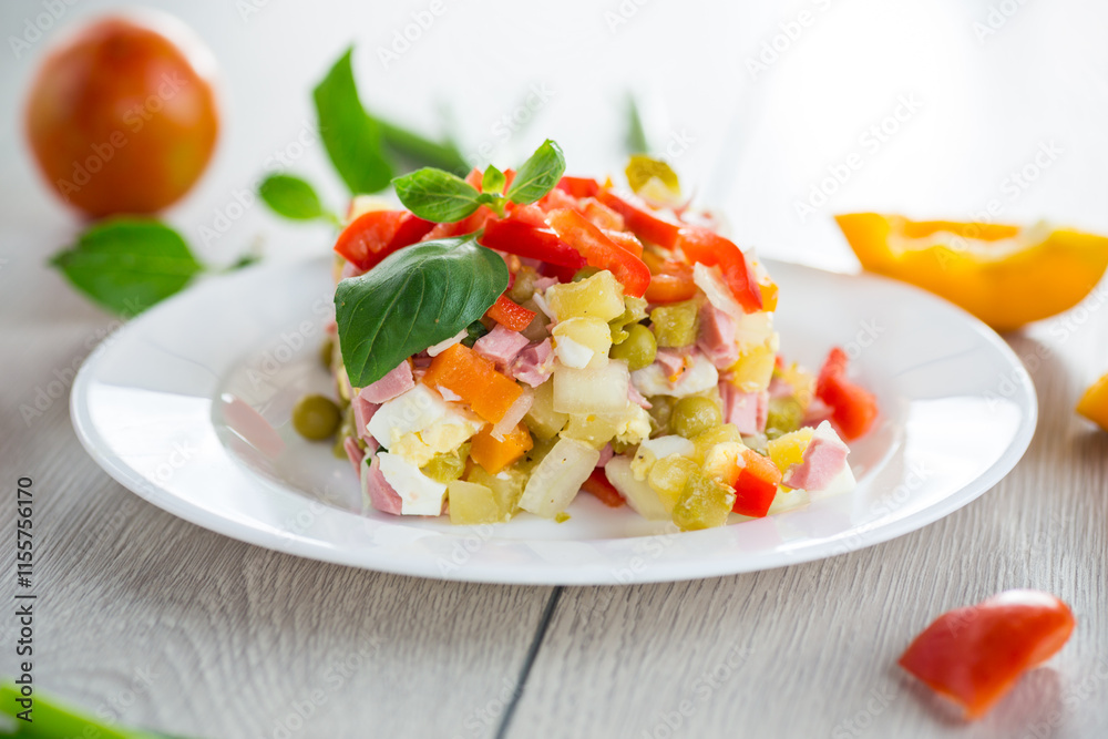 vegetable salad of boiled vegetables, with peas, sausage, sweet pepper. On a wooden table vegetable salad of boiled vegetables, with peas, sausage, sweet pepper. On a wooden table
