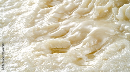 detailed close-up of animal fat being melted and poured into molds. The smooth texture of the fat contrasts with the raw materials, highlighting the transformation process in food and manufacturing. 