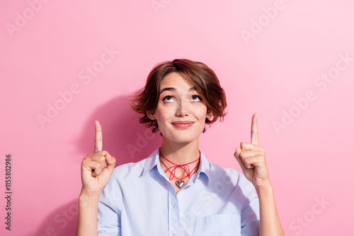 Portrait of gorgeous lady look direct fingers up empty space proposition isolated on pink color background