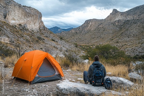 Peaceful camping experience by the lake surrounded by mountains during a cloudy day photo