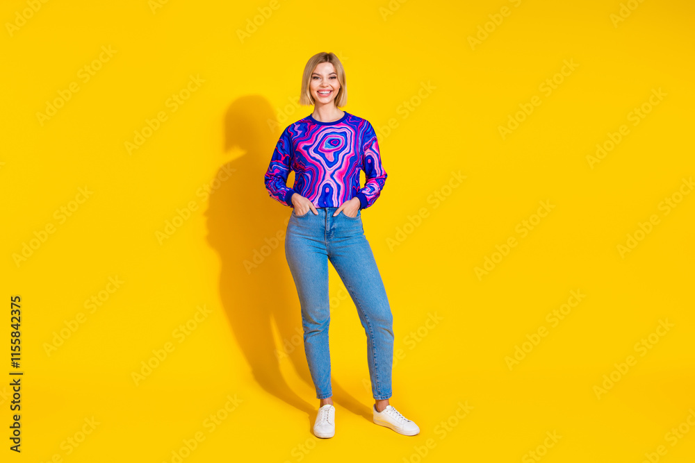 Fototapeta premium Full body photo of attractive young woman hands pockets posing dressed stylish colorful blue clothes isolated on yellow color background