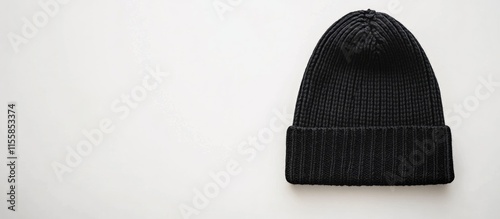 Black foldover beanie hat displayed on a white background with ample empty copyspace for personalized text or branding opportunities photo