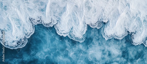 Aerial view of powerful ocean waves creating dynamic patterns in the turquoise sea with space for text and design elements photo