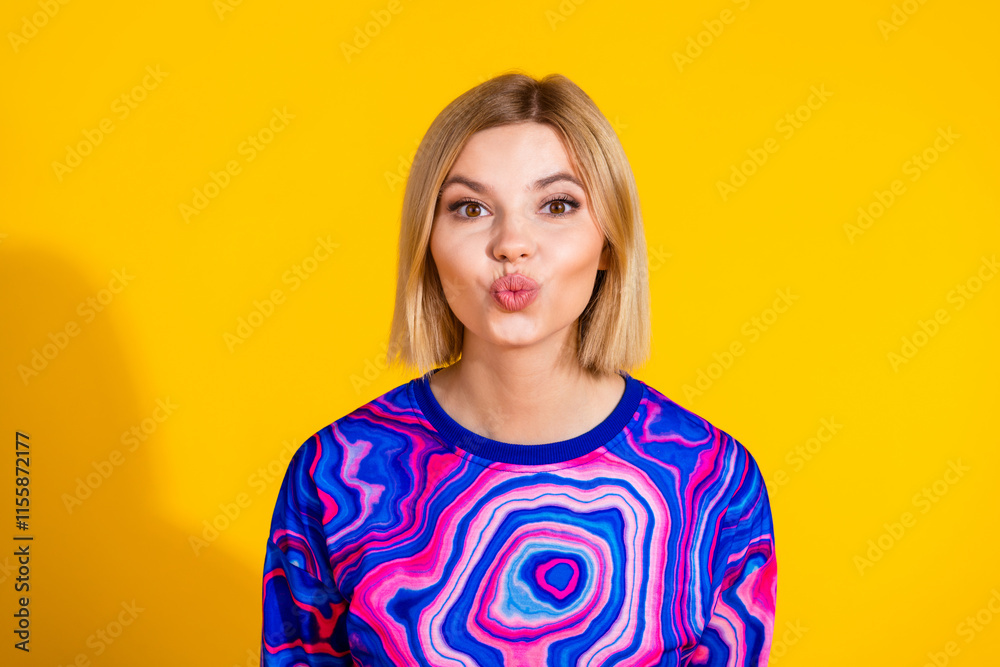 Photo portrait of attractive young woman kissing lips dressed stylish colorful blue clothes isolated on yellow color background Photo portrait of attractive young woman kissing lips dressed stylish colorful blue clothes isolated on yellow color background