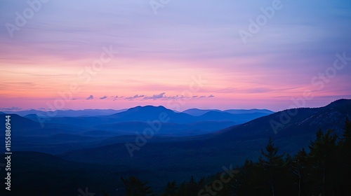 Serene sunset over layered mountain range.