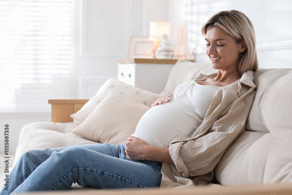 Portrait of beautiful pregnant woman on sofa at home Portrait of beautiful pregnant woman on sofa at home
