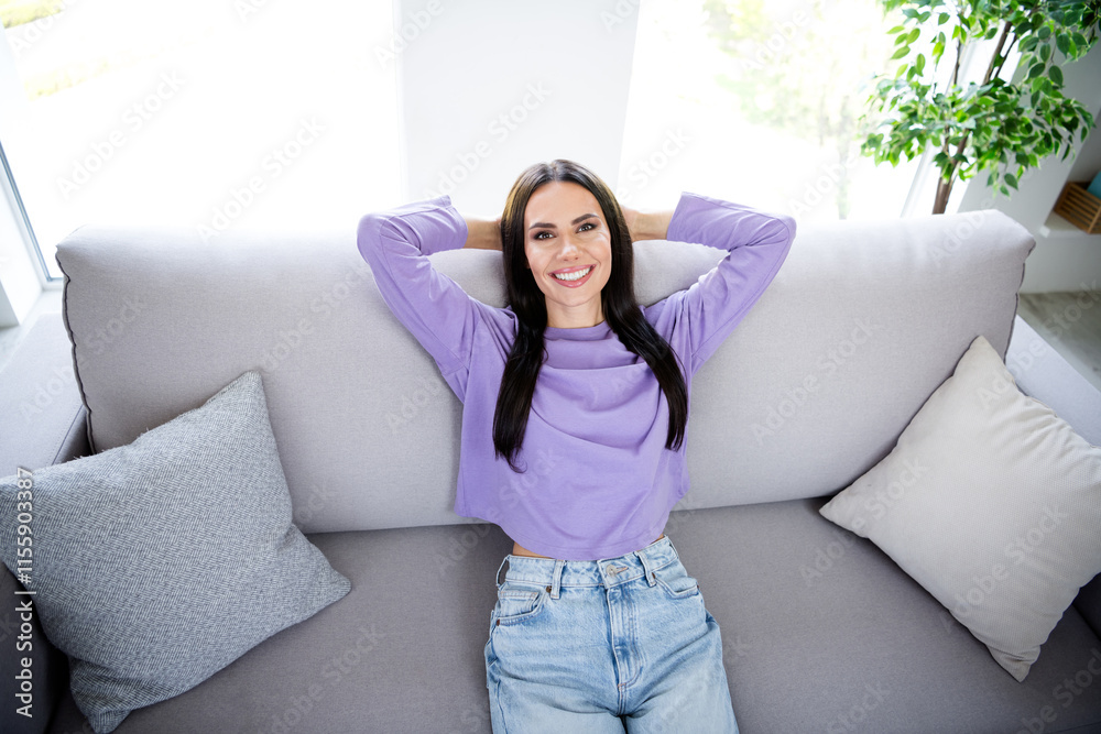 Young woman enjoying a relaxing weekend at home on a cozy sofa Young woman enjoying a relaxing weekend at home on a cozy sofa