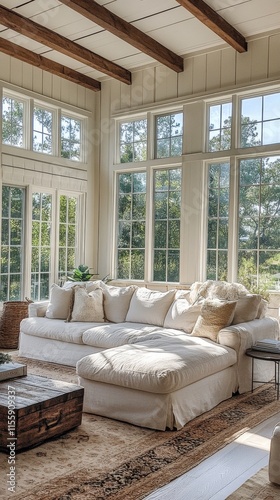 Bright and airy living room with large windows and lush plants during a sunny...