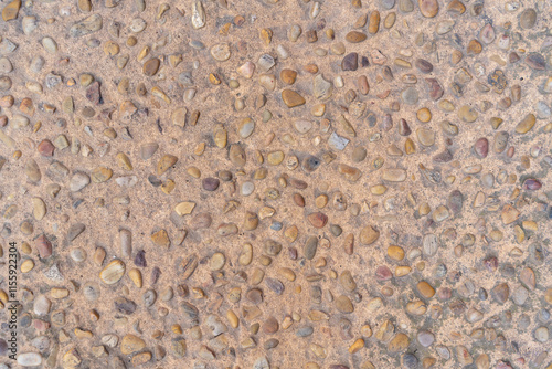 Capdepera, Mallorca, Spain 26.10.2021 Traditional Mediterranean stone pavement with rounded pebbles embedded in sandy concrete