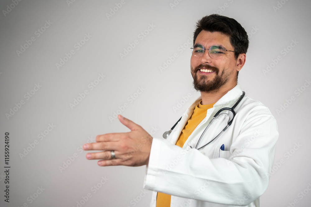 Friendly male doctor hold patient hand in office during recept. Compassionate male physician offering comfort to a patient by holding their hand in a welcoming clinic setting.