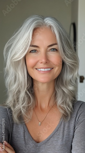 Smiling woman with silver hair and natural beauty in a bright indoor setting