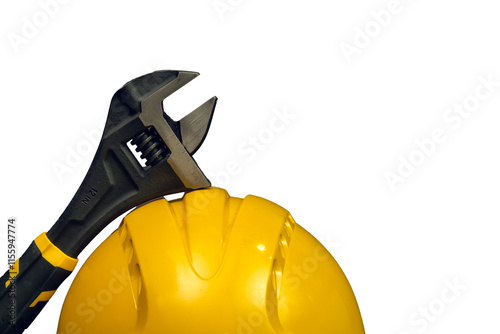 Obraz na płótnie Adjustable wrench leaning on a yellow safety helmet on white background w salonie