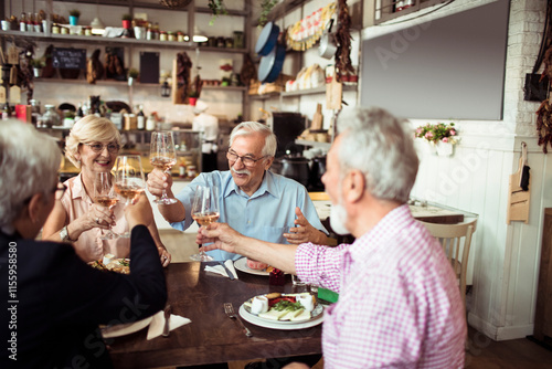 Senior friends eating meal at a cozy restaurant gathering photo