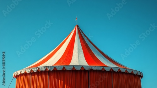 Colorful circus tent stands under a clear blue sky during daylight hours