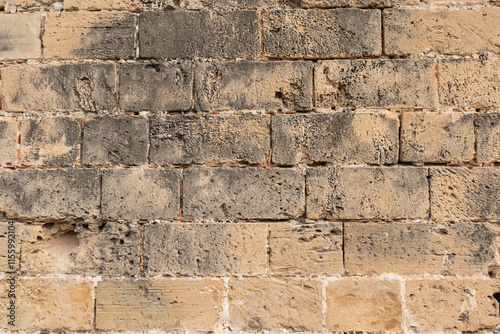 Palma de Mallorca, Spain 29.10.2021: Ancient weathered sandstone wall texture of La Almudaina Palace