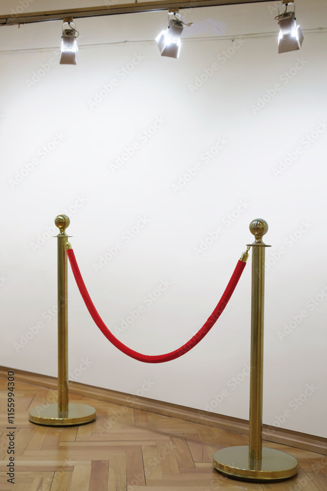 Golden barrier with red rope seamless line on a art gallery white wall background Golden barrier with red rope seamless line on a art gallery white wall background