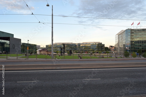 People are relaxing in front of the Kiasma museum and Sanoma building in Helsinki, Finland.  photo