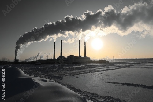 Colorful sunset over snowy street with factory smoke in background during win...
