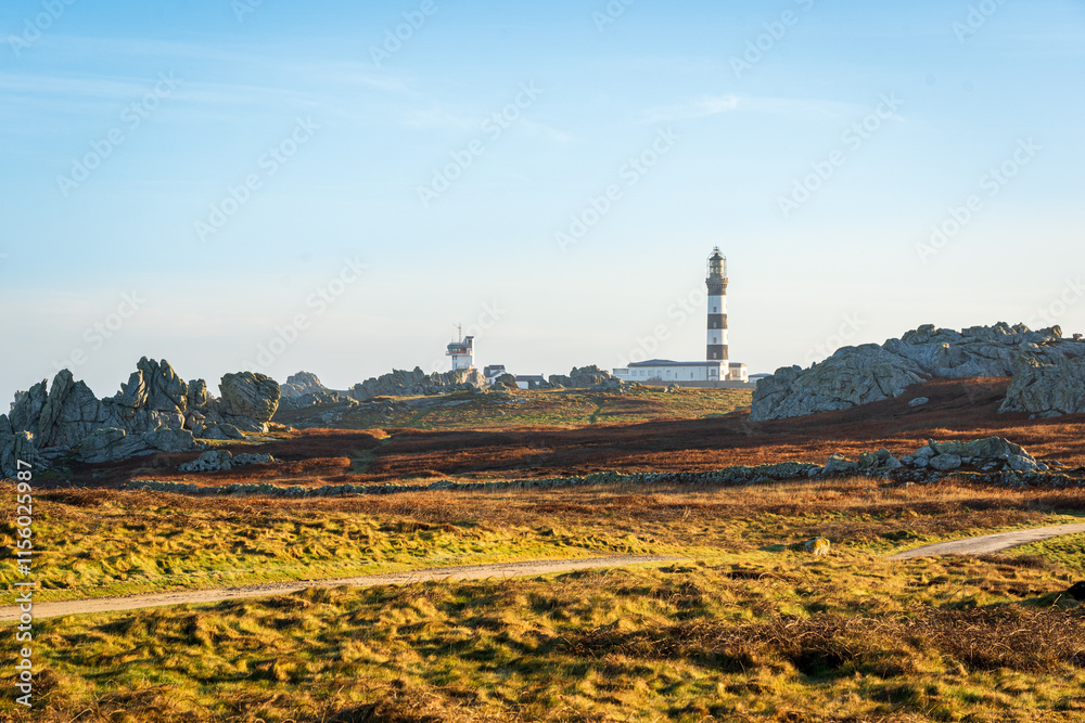 Fototapeta premium Scenic View of Phare du Créac'h Lighthouse on Rugged Landscape in Ouessant, Brittany, France Captured in Serene Light