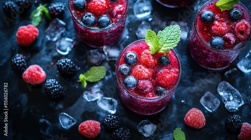 Fresh berry drinks with ice and mint leaves on a dark background photo