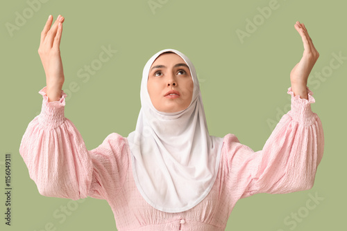 Young Muslim woman praying ...