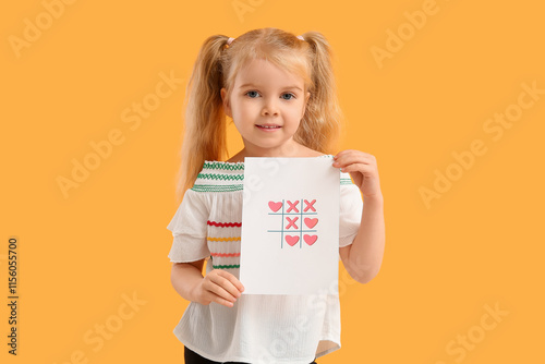 Cute little girl with greeting card on yellow background. Valentine's Day celebration