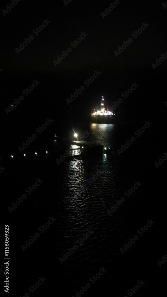 port harbor oil rigs beautifully illuminated against dark night sky energy industry impact dynamic aerial gas pollution environment drone nighttime lights reflection scenic landscape port harbor oil rigs beautifully illuminated against dark night sky energy industry impact dynamic aerial gas pollution environment drone nighttime lights reflection scenic landscape