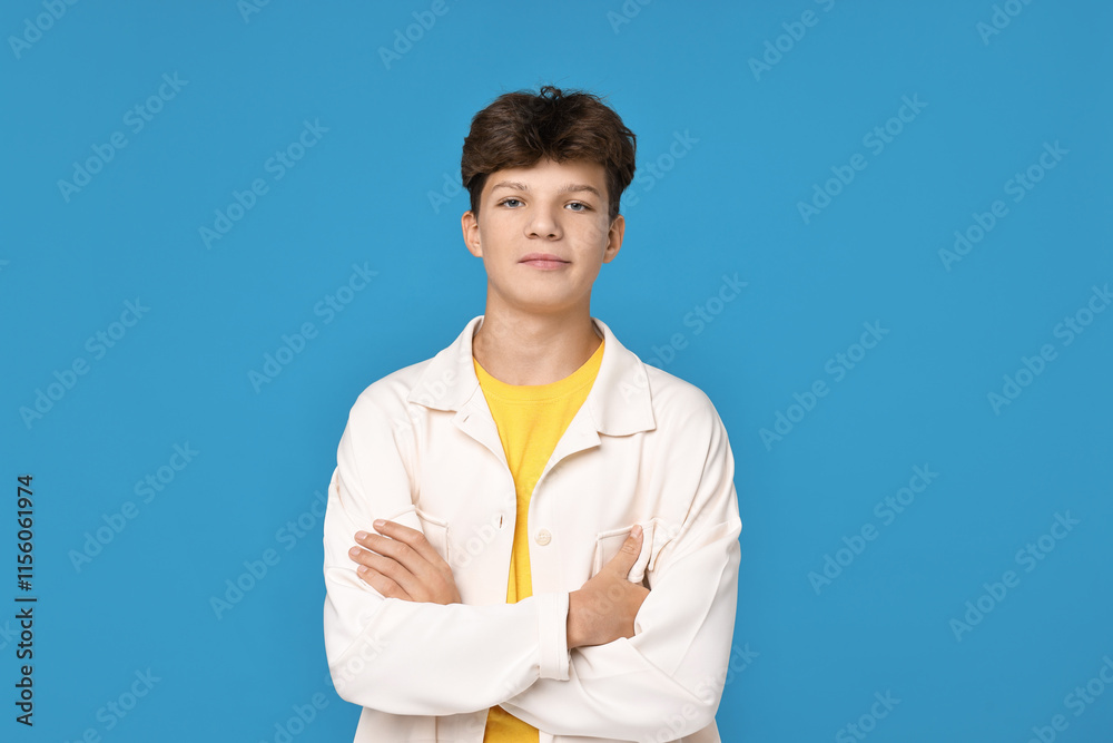 Portrait of teenage boy on light blue background Portrait of teenage boy on light blue background