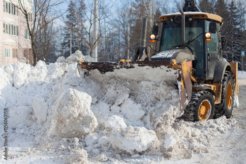 Snow removal in the city. Special equipment for removing snow from the road.