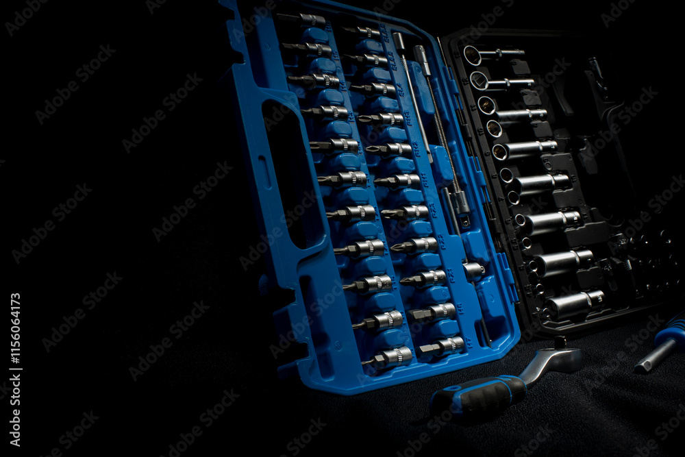 Car chrome silver tool kit with socket wrench on a dark background. Car chrome silver tool kit with socket wrench on a dark background.