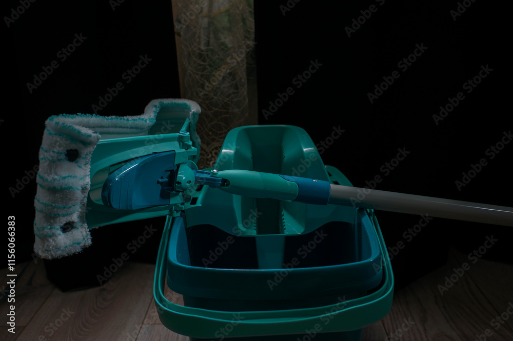 Equipment for cleaning the house in the living room.A mop and bucket are used as household cleaning tools. Equipment for cleaning the house in the living room.A mop and bucket are used as household cleaning tools.