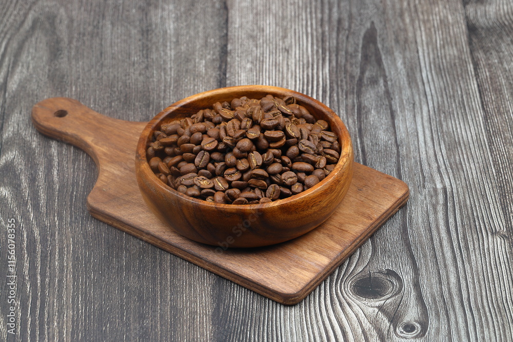 Wooden bowl with coffee beans on wooden background Wooden bowl with coffee beans on wooden background