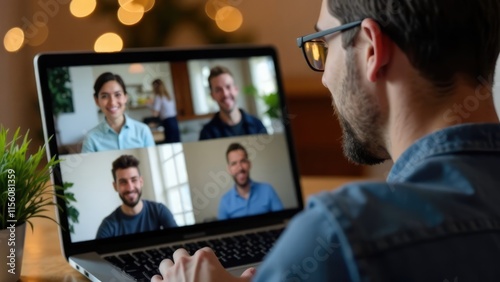 A man is participating in a video call on his laptop with four other people visible on screen.
Concept of: Virtual communication. photo