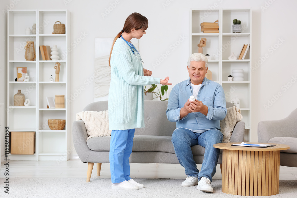 Female doctor and mature man with pills sitting on sofa at home Female doctor and mature man with pills sitting on sofa at home