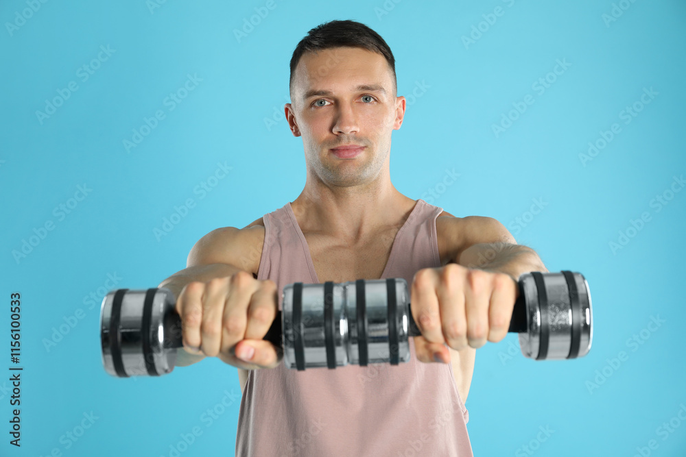 Man exercising with dumbbells on light blue background Man exercising with dumbbells on light blue background