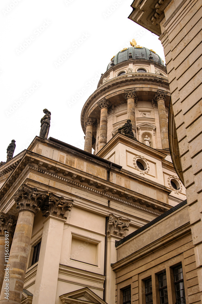 Low angle view of a historical Franzoesischer Dom. French Cathedral in Berlin, a historical landmark and popular tourist attraction. Cultural and architectural heritage, tourism and sightseeing. Copy 