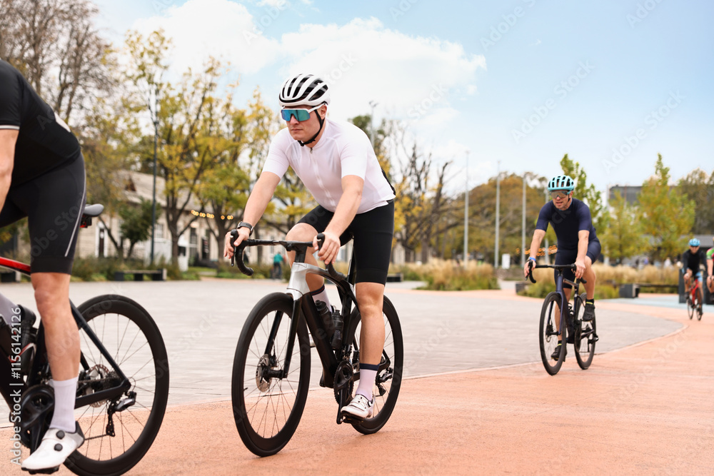 Fototapeta premium Group of athletic people riding bicycles outdoors