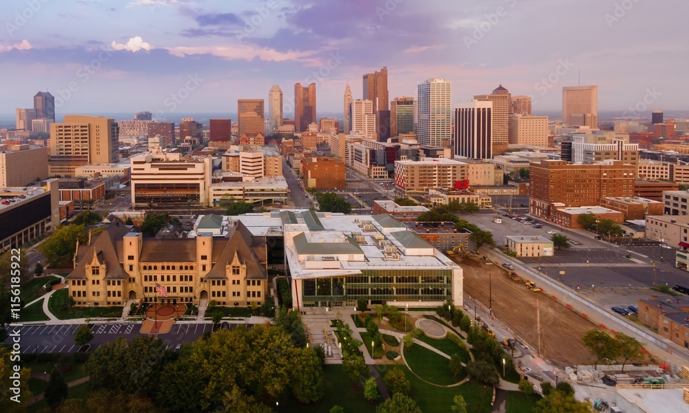 Fototapeta premium Columbus, OH skyline at dawn, showcasing urban development and construction. Modern buildings, historical architecture, and a park are visible. DOWNTOWN, COLUMBUS, OHIO, UNITED STATES