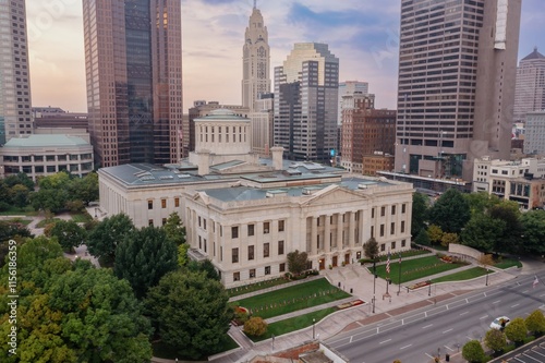 High-angle view of the Ohio Statehouse in Columbus, Ohio. Flags line the lawn, showcasing the city's civic pride. OHIO STATEHOUSE, COLUMBUS, OHIO, UNITED STATES