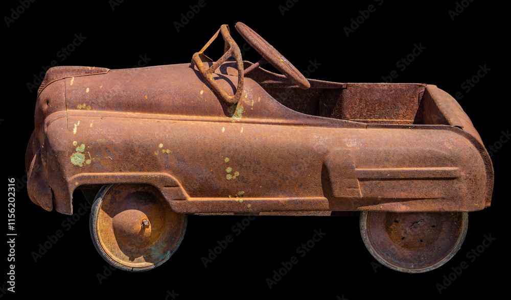 This rusty vintage pedal car with a weathered patina showcases an antique toy from the mid-20th century, exuding nostalgic charm and historic appeal.