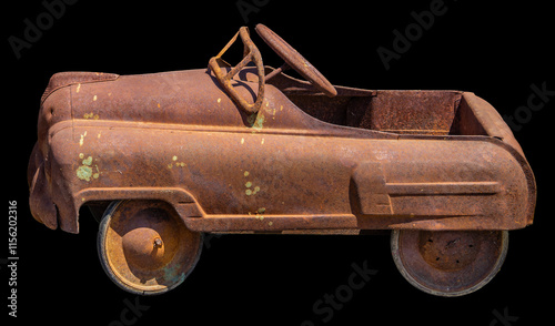 Obraz na płótnie This rusty vintage pedal car with a weathered patina showcases an antique toy from the mid-20th century, exuding nostalgic charm and historic appeal. w salonie