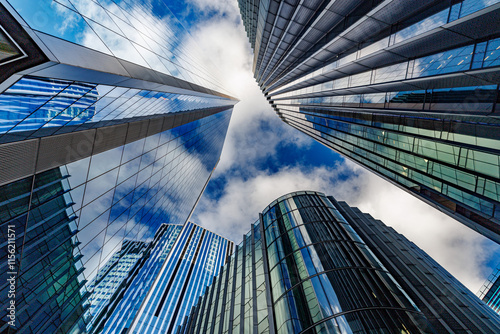 Fototapeta Naklejka Na Ścianę i Meble -  skyscraper buildings in business district, London City. Cloud on sunny day sky. Low angle view. Europe financial economy, merger and acquisition, or modern architecture concept, blue urban background