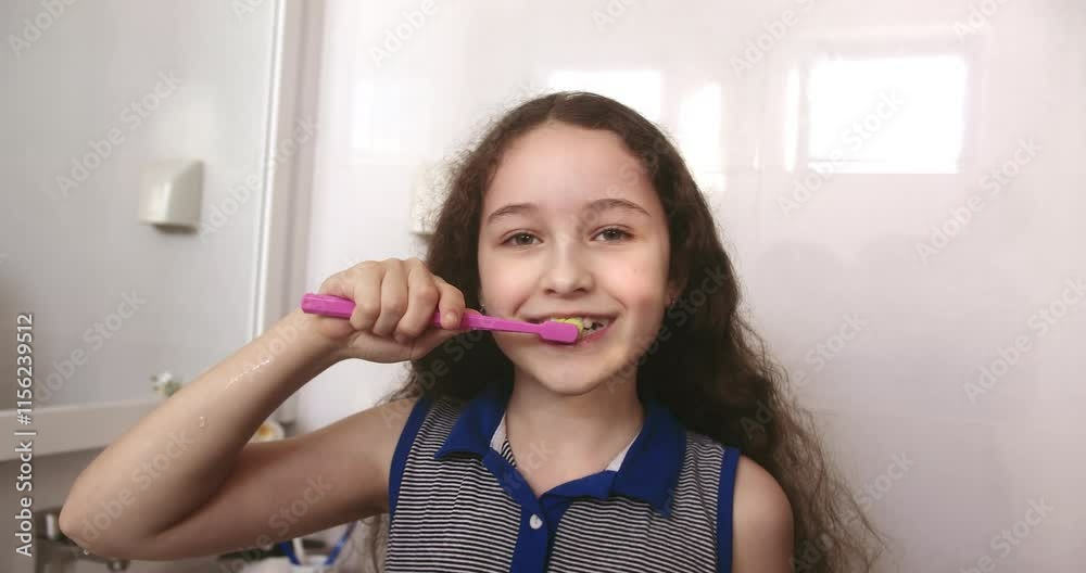 Kid little girl daily healthcare routine. Child with white tooth looking at mirror isolated at home. Smiling Lifestyle. Portrait cute Caucasian Young teenage girl brushing teeth in bathroom. 4K Kid little girl daily healthcare routine. Child with white tooth looking at mirror isolated at home. Smiling Lifestyle. Portrait cute Caucasian Young teenage girl brushing teeth in bathroom. 4K