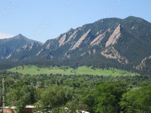 Green meadows at the foothills of Flatirons, Rocky mountains, Boulder, Colorado photo