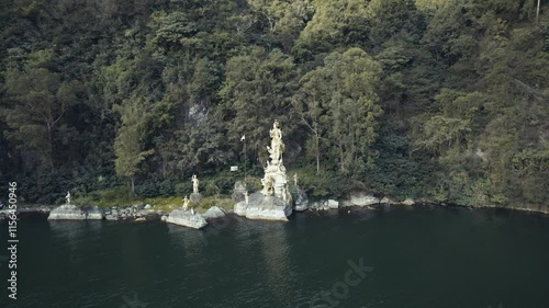 Wallpaper Mural Flight towards the Golden statue Pura Ulun Danu Bangli at Batur Lake, near east caldera Batur volcano, in Bali island, Indonesia Torontodigital.ca
